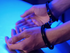 A person's hands in handcuffs